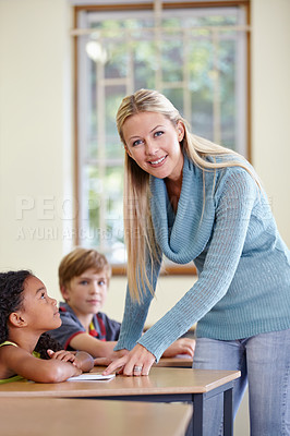 Buy stock photo Portrait, woman and smile of teacher in classroom helping students in class. Teaching, female educator and happy person with children learning in primary school for education, studying or knowledge.