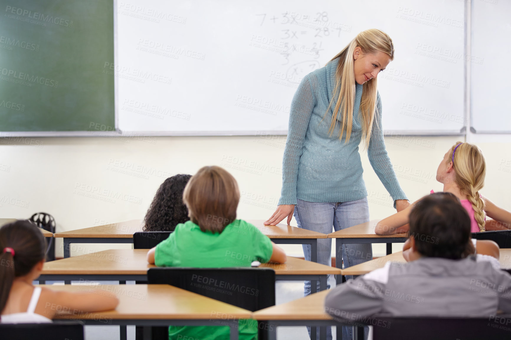 Buy stock photo Teacher, kids and students in classroom for learning, education and math support or development at desk. Happy woman with children for teaching numbers, helping with knowledge and questions at school