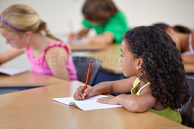 Buy stock photo School, girl and writing in book in classroom for education, studying lesson or learning assessment at desk. Children, student or kids drawing in notebook for academic development, test or knowledge 