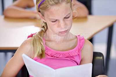 Buy stock photo Girl, reading and book with education, classroom and knowledge with concentration, creativity and thinking. Child development, school and kid with literature, ideas and information with learning
