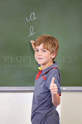 Buy stock photo Portrait, child and student with thumbs up on blackboard in classroom, elementary school and mockup. Chalkboard, education and kid with hand gesture for like emoji, agreement and learning to write.