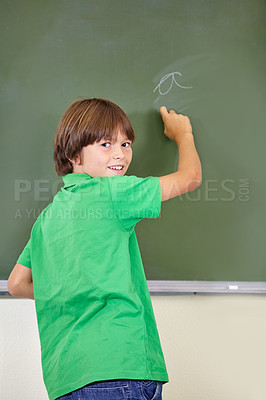 Buy stock photo Portrait, smile and boy drawing on a chalkboard for child development, answers and art for learning. Academic, creative and kid student writing letters in the classroom with art, excited and happy