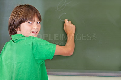 Buy stock photo Writing, chalkboard and portrait of kid at school with education and answer for learning. Drawing, knowledge and youth development in study lesson with boy in classroom with chalk and solution