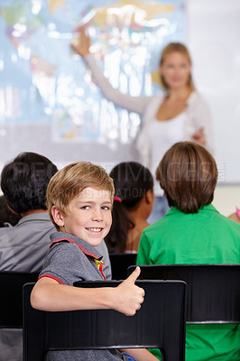 Buy stock photo Kid, portrait and thumbs up of student in classroom, elementary school or class. Smile, education and child with hand gesture for like emoji, agreement or learning, success and sign of approval.