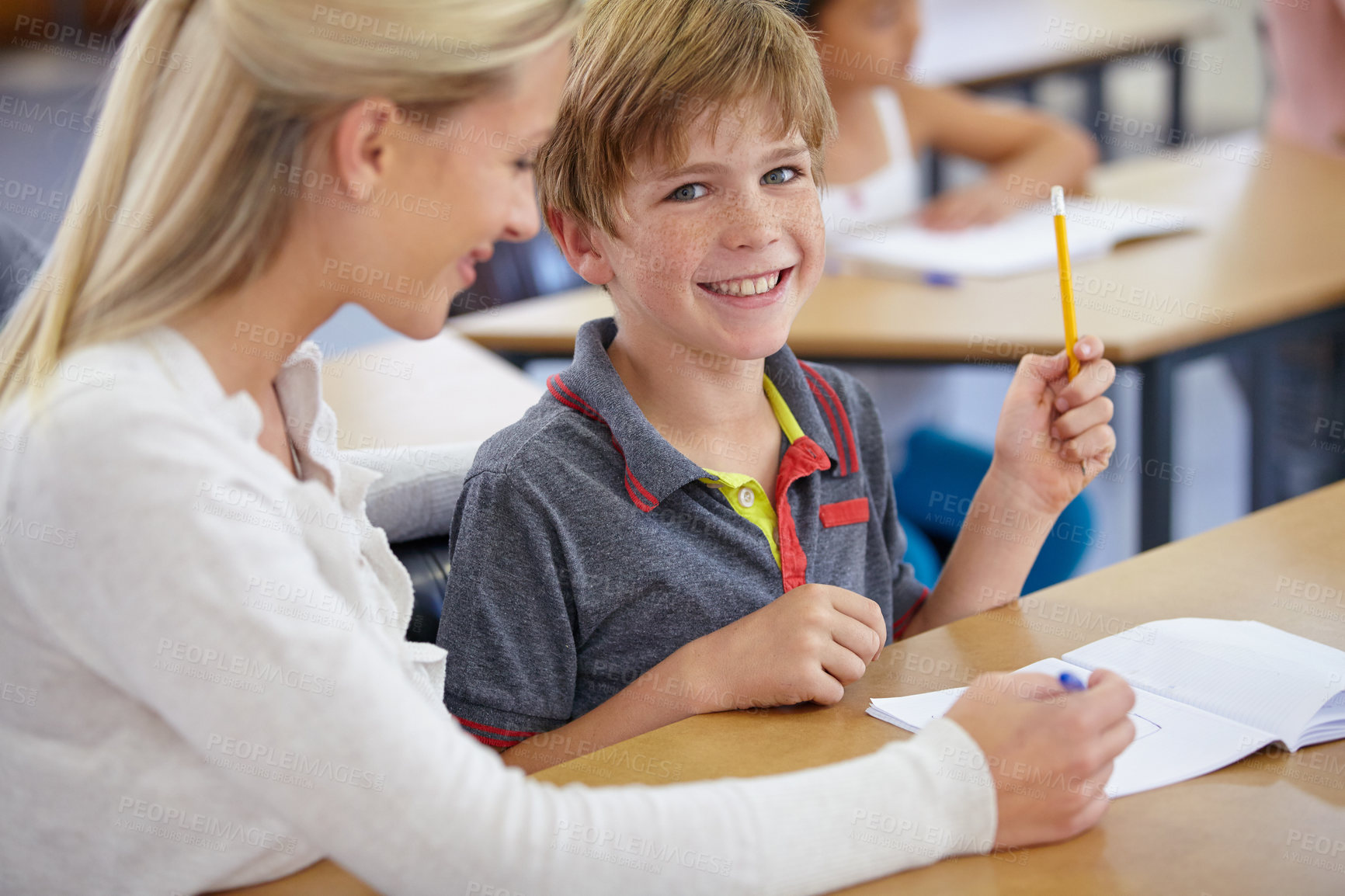 Buy stock photo Teacher, child portrait and classroom for learning, education and writing or language development with support. Happy woman teaching, helping and face of student with knowledge or questions at school