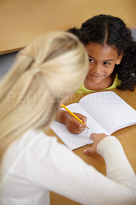 Buy stock photo Woman helping girl, education and writing in notebook with pencil, teaching and learning for growth and development. People in classroom to learn, academic study with teacher and student at school
