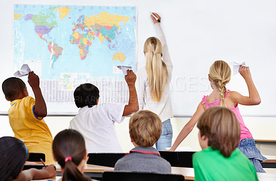 Buy stock photo Naughty students, paper plane or teacher in classroom, elementary school for child development. Throw, teaching or back of educator with knowledge or children for learning, education or geography