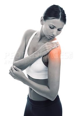 Buy stock photo A young woman in sportswear rubbing her shoulder