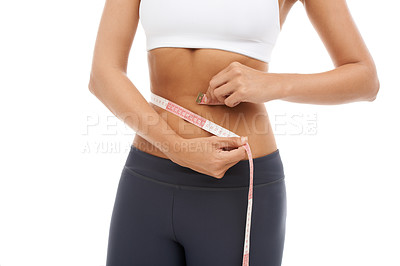 Buy stock photo Hands, closeup and woman with measuring tape to lose weight in studio or white background. Fitness, check and stomach of person with measurement, size of body and progress for health and wellness 