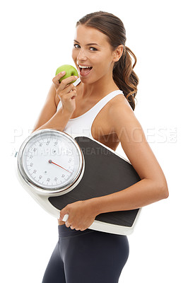 Buy stock photo A fit young woman carrying a scale and enjoying a delicious apple