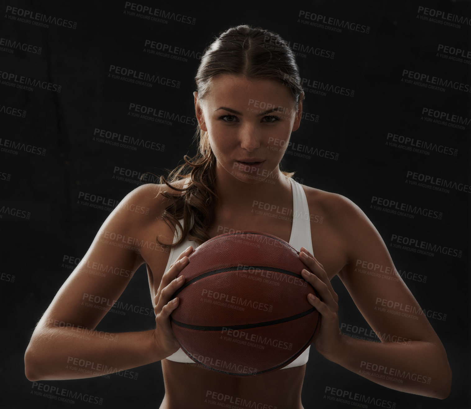 Buy stock photo Cropped view of a young woman in sportswear holding a basketball