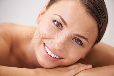 Buy stock photo Relax, happy and young woman at spa with body massage for health, wellness and self care. Smile, natural and female person with calm, peaceful and serene skin therapy treatment at beauty salon.