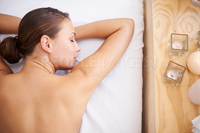Buy stock photo A young woman lying in a health spa getting pampered