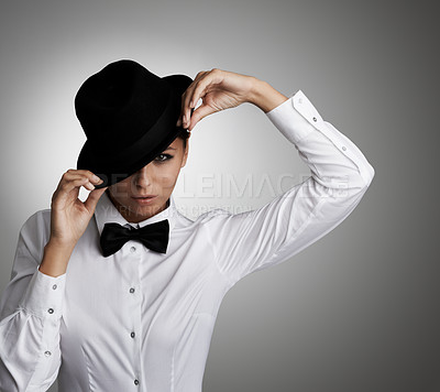 Buy stock photo A young woman in a shirt and bow tie tipping her hat to you