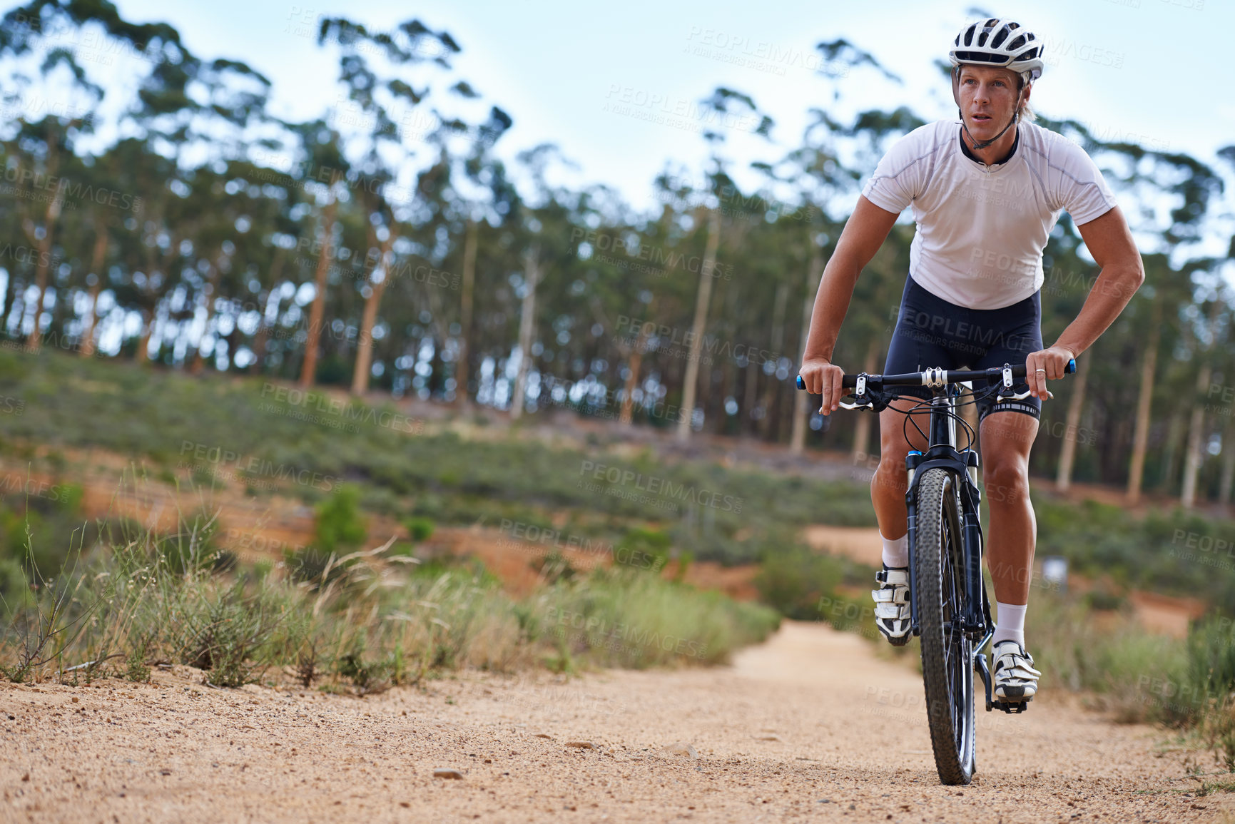 Buy stock photo Man, mountain bike and cycling in forest for fitness sports or outdoor, exercise or athlete. Male person, transportation and off road terrain for countryside training or health, workout or adventure