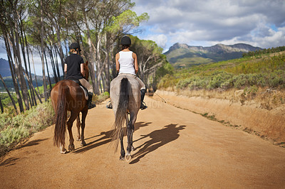 Buy stock photo Rear-view of two women on horseback - riding trail