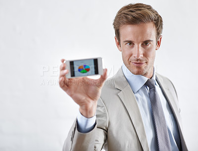 Buy stock photo Business man, phone screen and data, statistics or pie chart for financial report, revenue and stock market. Portrait of corporate accountant on mobile for trading or sales on a white wall background