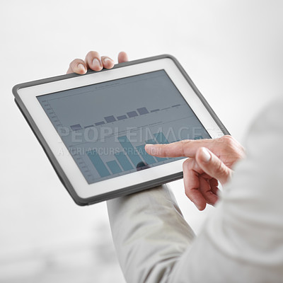 Buy stock photo Cropped image of a businessman holding a digital tablet showing business data