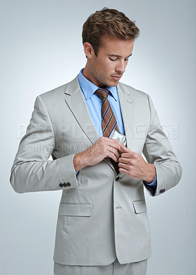 Buy stock photo Businessman, face and money or stealing in studio for temptation, white collar crime or investment. Finance, entrepreneur and person with cash and fraud at corporate job on gray background