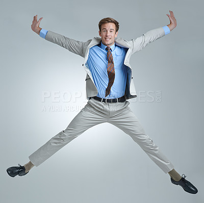Buy stock photo Businessman, celebration and jumping for triumph in portrait, studio and corporate winner. Male person, professional and victory or accomplishment, cheering and energy or bonus by gray background