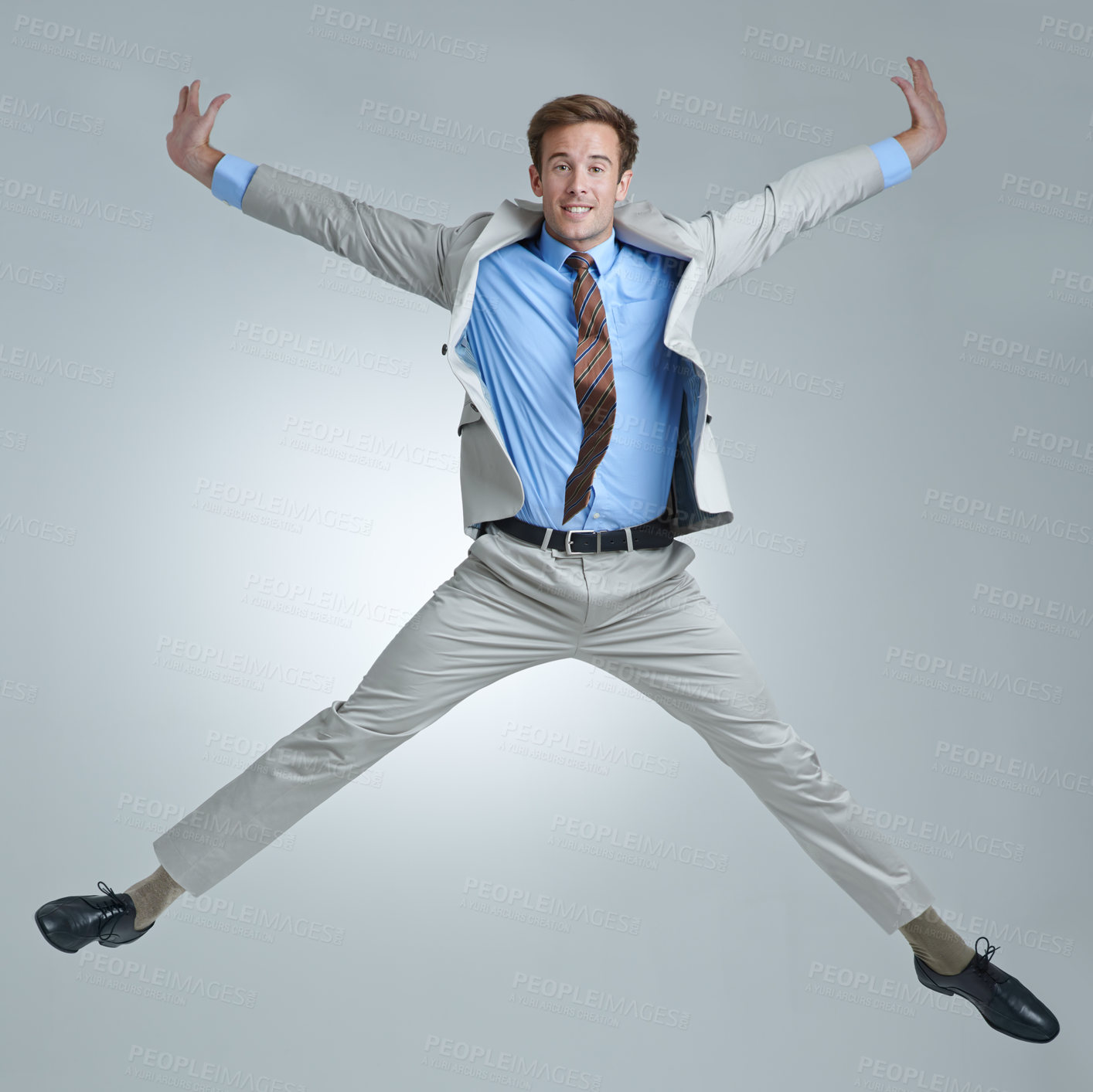 Buy stock photo Businessman, celebration and jumping for triumph in portrait, studio and corporate winner. Male person, professional and victory or accomplishment, cheering and energy or bonus by gray background