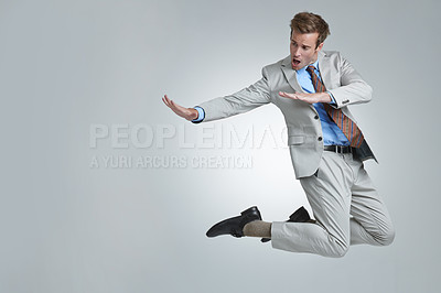 Buy stock photo A young businessman wildly celebrating his success