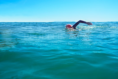 Buy stock photo Swimming, stroke and person in ocean water in summer for exercise, training or workout on mockup space. Sea, sport and a young athlete outdoor for fitness, health and triathlon competition in nature