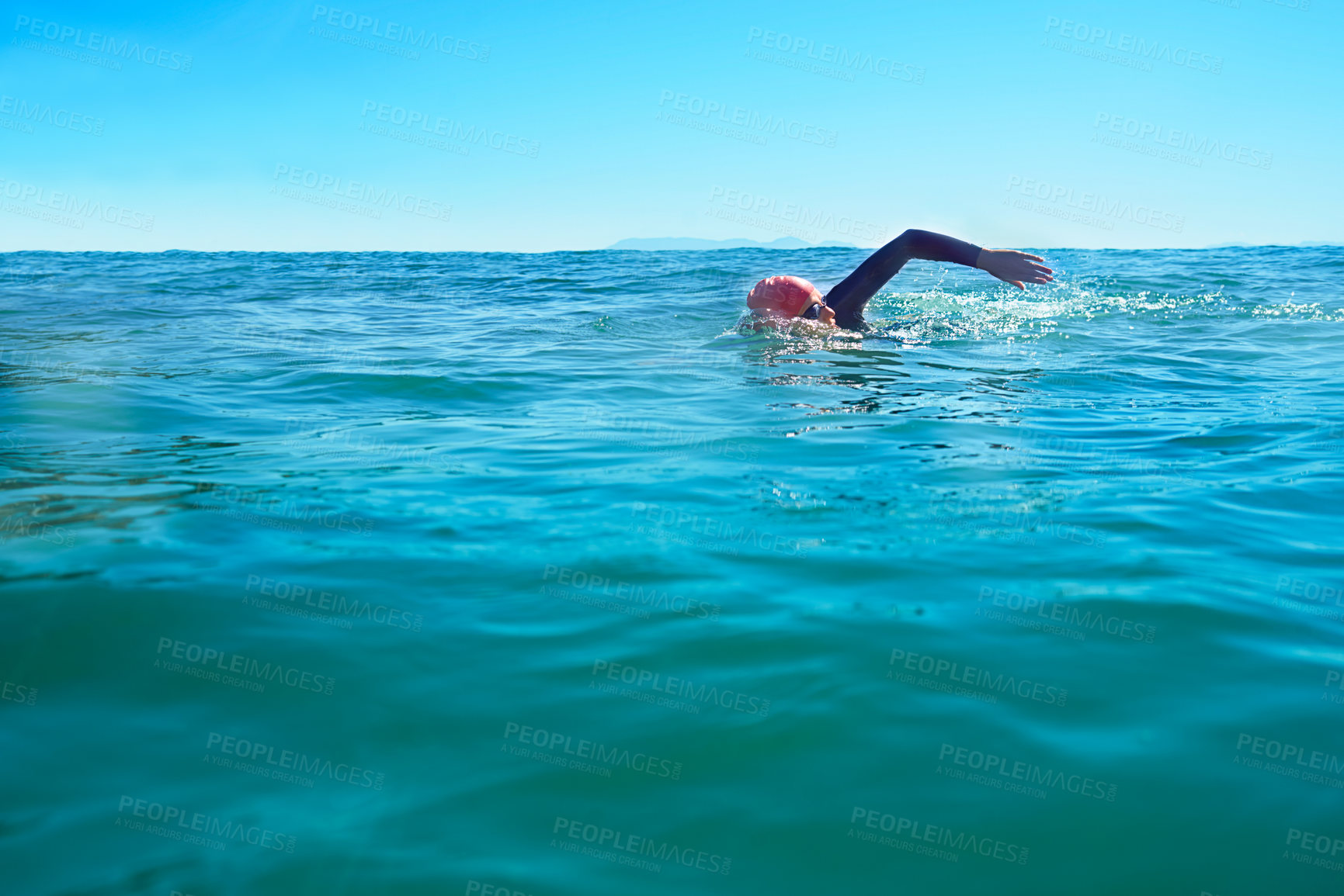 Buy stock photo Swimming, stroke and person in ocean water in summer for exercise, training or workout on mockup space. Sea, sport and a young athlete outdoor for fitness, health and triathlon competition in nature