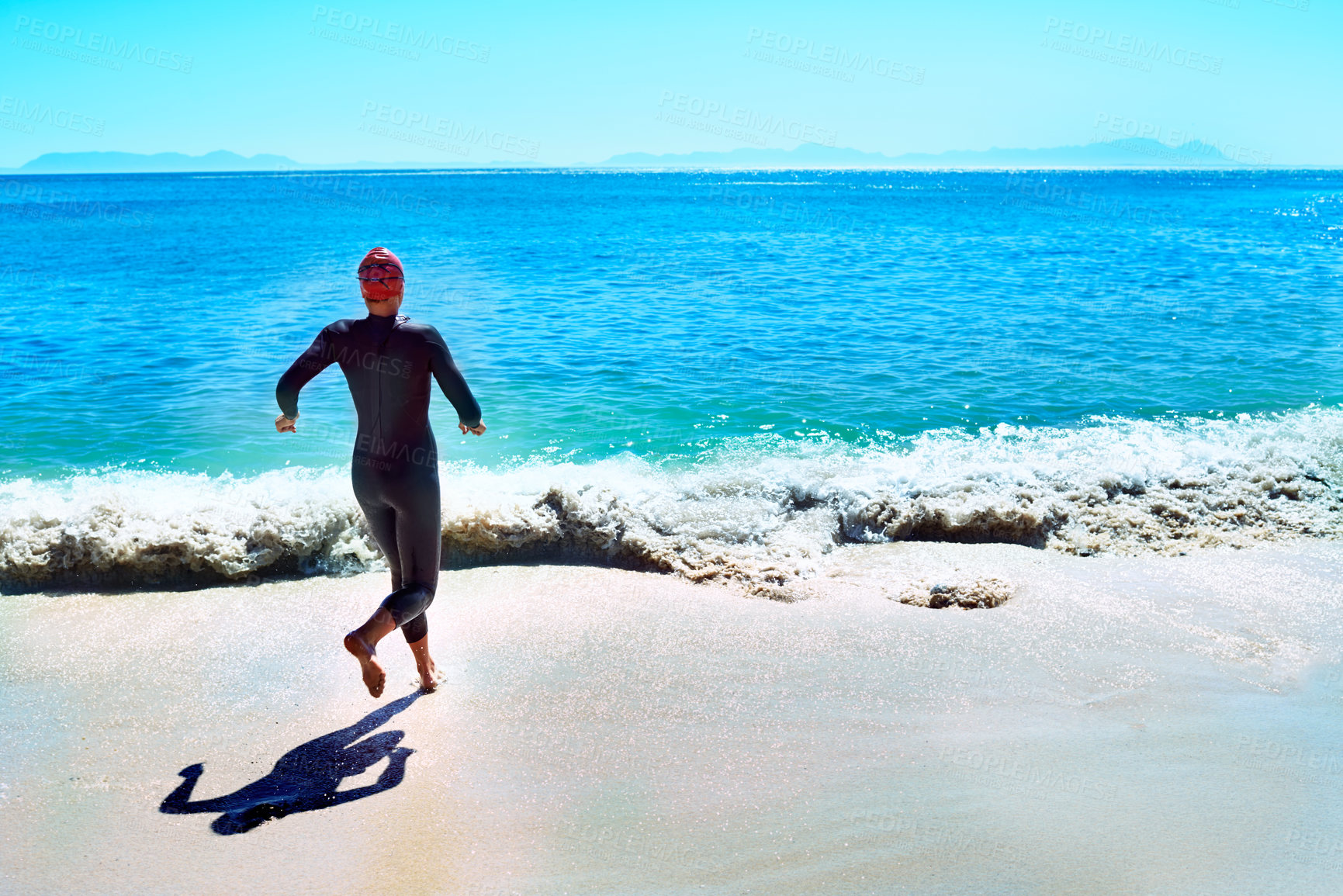 Buy stock photo Swimming, back and woman running to sea at beach in summer for exercise, training or workout on mockup space. Ocean, sport and rear view of athlete at water outdoor for fitness, health or triathlon