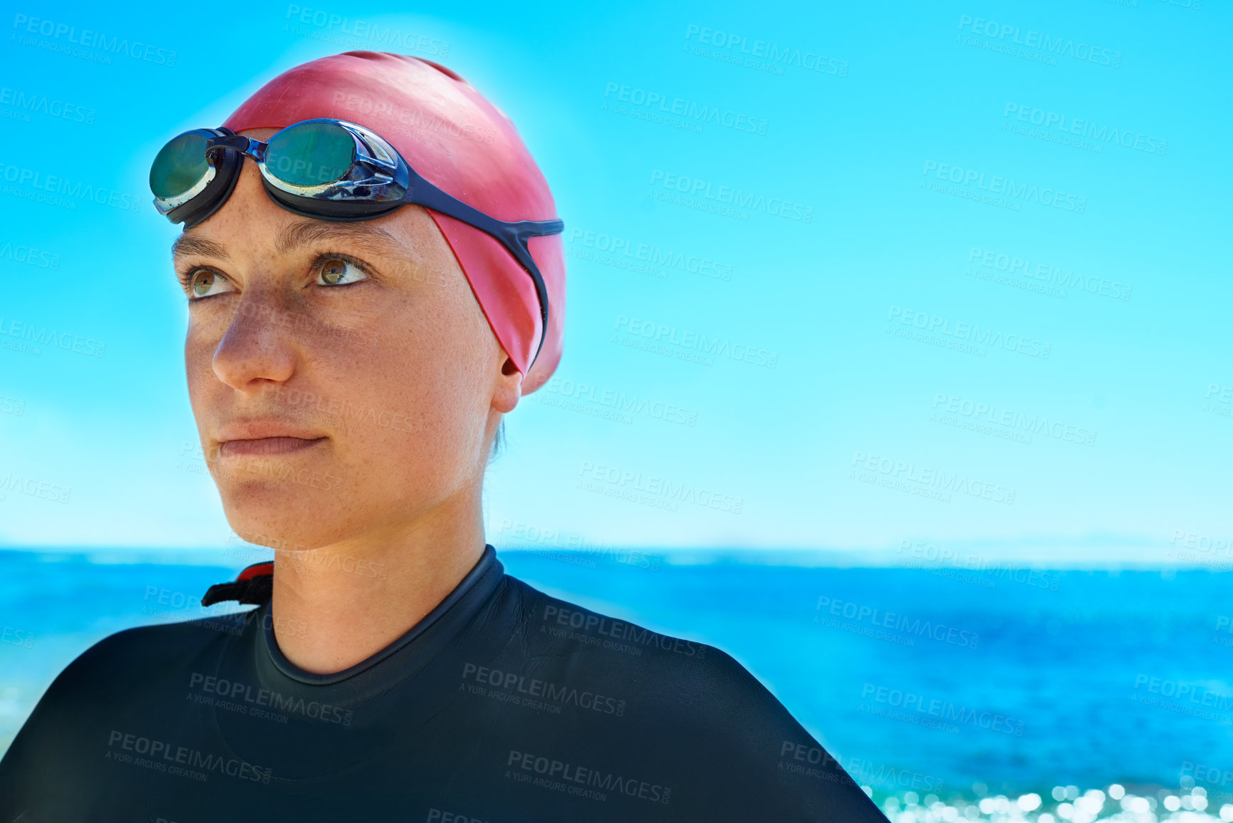 Buy stock photo Swimmer sport, face and woman at ocean outdoor in summer for exercise, thinking of training or vision. Sea, athlete and person in goggles for fitness, health or idea at beach water on mockup space