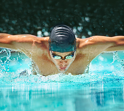 Buy stock photo Water splash, sport and training with man in swimming pool for competition, workout and energy. Strong, fitness and cardio with male swimmer and practice for athlete, championship and race at gala