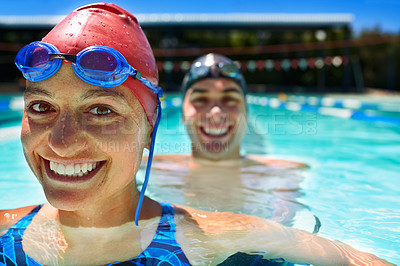 Buy stock photo Two swimmer standing in a pool smiling