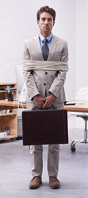 Buy stock photo Sad businessman in office tied up in rope with depression, control and prisoner in law firm. Serious attorney, lawyer or legal consultant bound at work, corporate hostage with briefcase and stress.