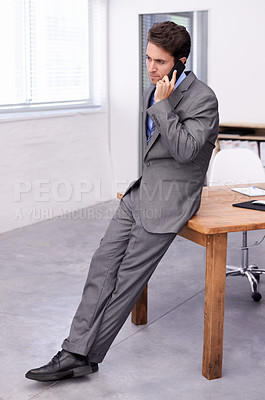 Buy stock photo Young businessman, phone call and talking in his office, consulting and discussion in problem solving. Accountant, communication and smartphone on feedback review in company, serious and professional