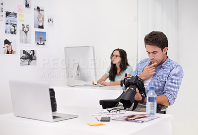 Buy stock photo Camera, man and photographer with photoshoot for quality control in a studio or workshop for production. Creative, photography and artist with dslr equipment for picture inspection in modern office.