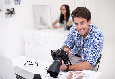 Buy stock photo Camera, portrait and photographer looking at photoshoot in a studio or workshop for production. Creative, smile and artist with dslr equipment for photography picture inspection in modern workplace.