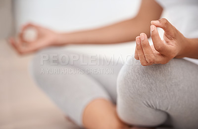 Buy stock photo Cropped shot a young woman meditating at home
