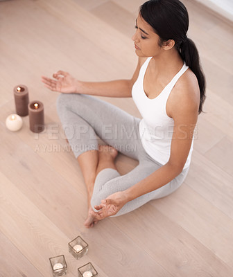 Buy stock photo Woman, calm meditation and spiritual in a home with candles and chakra for balance and mindfulness. Morning, wellness and zen in house on floor to relax for breathing and peace in lotus position