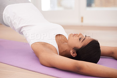 Buy stock photo Woman, yoga and stretching body for exercise, pilates or wellness in fitness or workout at home. Young and calm female person or yogi lying on floor mat in relax for zen, warm up or stretch at house