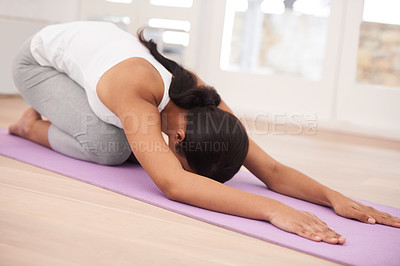 Buy stock photo A young woman exercising in her home