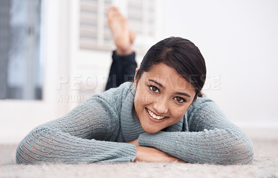 Buy stock photo Portrait of woman on carpet with smile, relax and weekend break to unwind in living room at house. Face of girl lying on floor of apartment to chill with happiness, peace and calm in lounge at home.