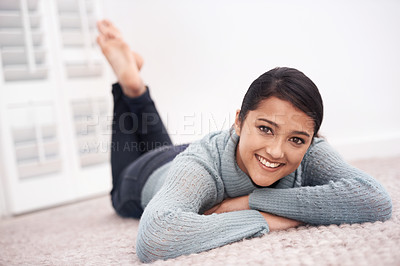 Buy stock photo Portrait of girl on carpet with smile, relax and weekend break to unwind in living room at house. Face of woman lying on floor of apartment to chill with happiness, peace and calm in lounge at home.