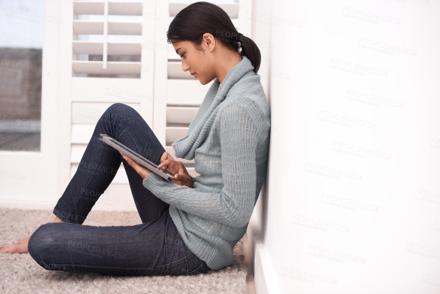 Buy stock photo Woman on floor with tablet, reading and relax with studying, web research and social media post in living room. Student girl on carpet with digital app, elearning and checking blog online in home.