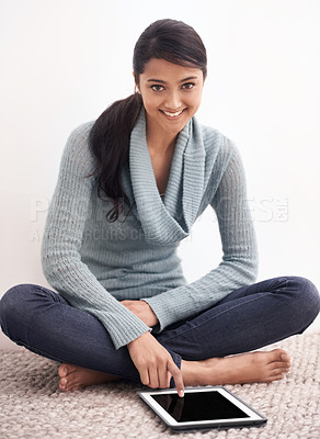 Buy stock photo Portrait of happy woman sitting on carpet with tablet, smile and relax for studying, research and social media in living room. Student girl on floor with digital app, elearning or online blog in home
