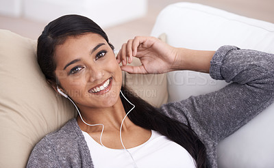 Buy stock photo Portrait of happy woman on sofa with smile, earphones and relax with mobile app for podcast in house. Face of girl lying on couch with headphones, music and streaming service for online radio in home