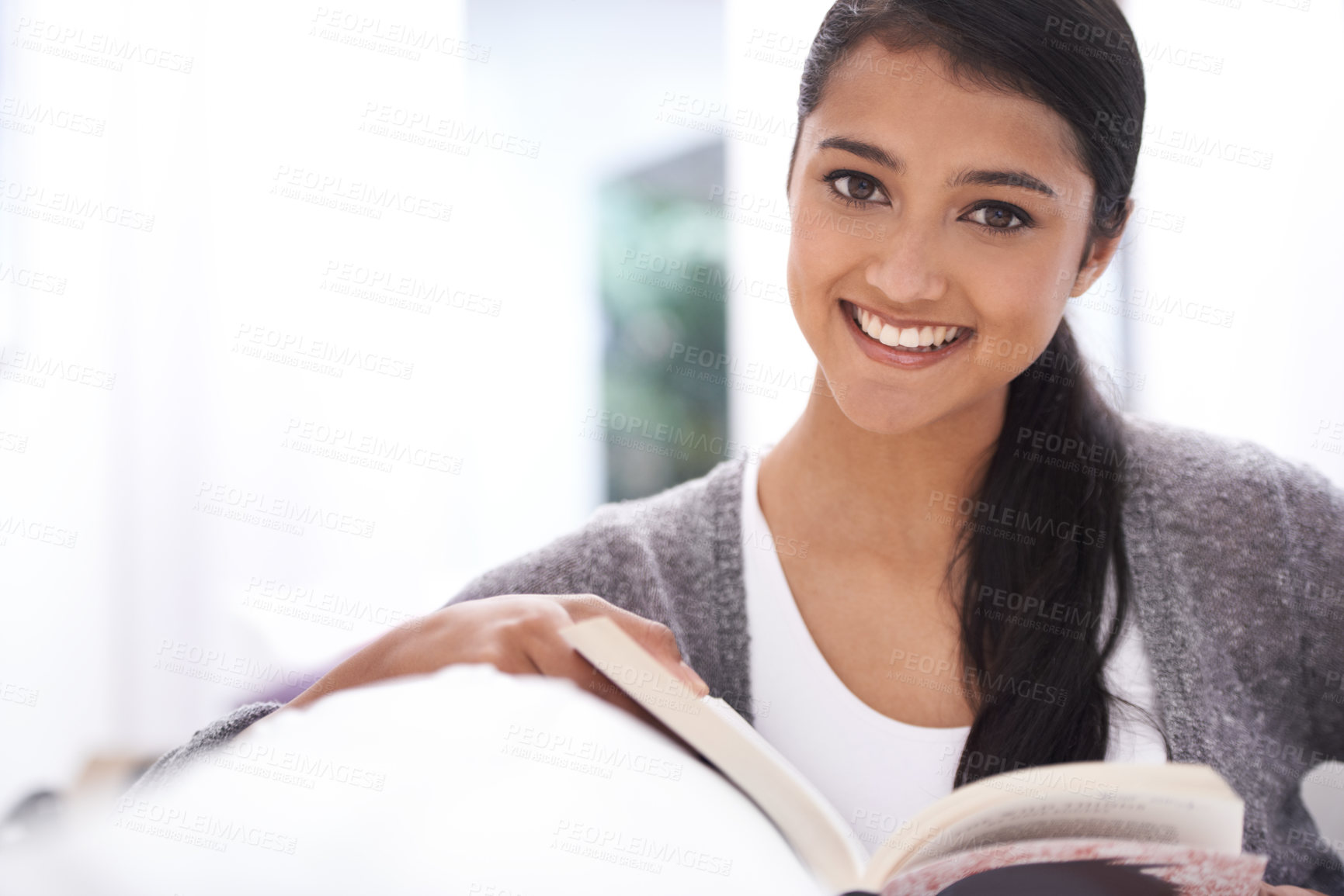 Buy stock photo Portrait of woman, reading book and home education, learning or happy with literature, language and leisure. Face of student in living room with a novel, story or textbook for knowledge and studying