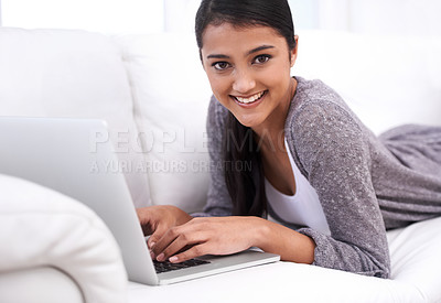 Buy stock photo Portrait, home and woman with a laptop, smile and typing in a living room, internet and connection. Face, person on a couch or girl in a lounge, technology and website with daily blog and digital app
