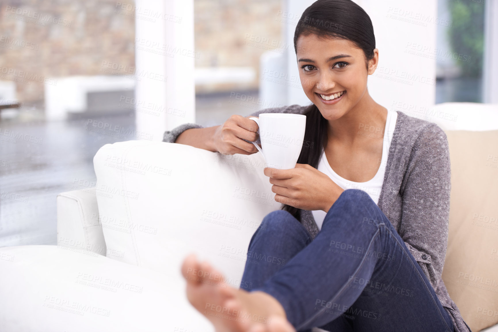 Buy stock photo Coffee, happy and portrait of Indian woman on sofa for relaxing, comfortable and calm in home. Apartment, morning and person with mug on couch drinking hot beverage, tea and caffeine in living room