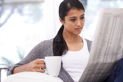 Buy stock photo Woman, reading and newspaper with coffee in a home in the morning with story, article and news. Relax, press print and calm person from India with paper publication and tea in house with information