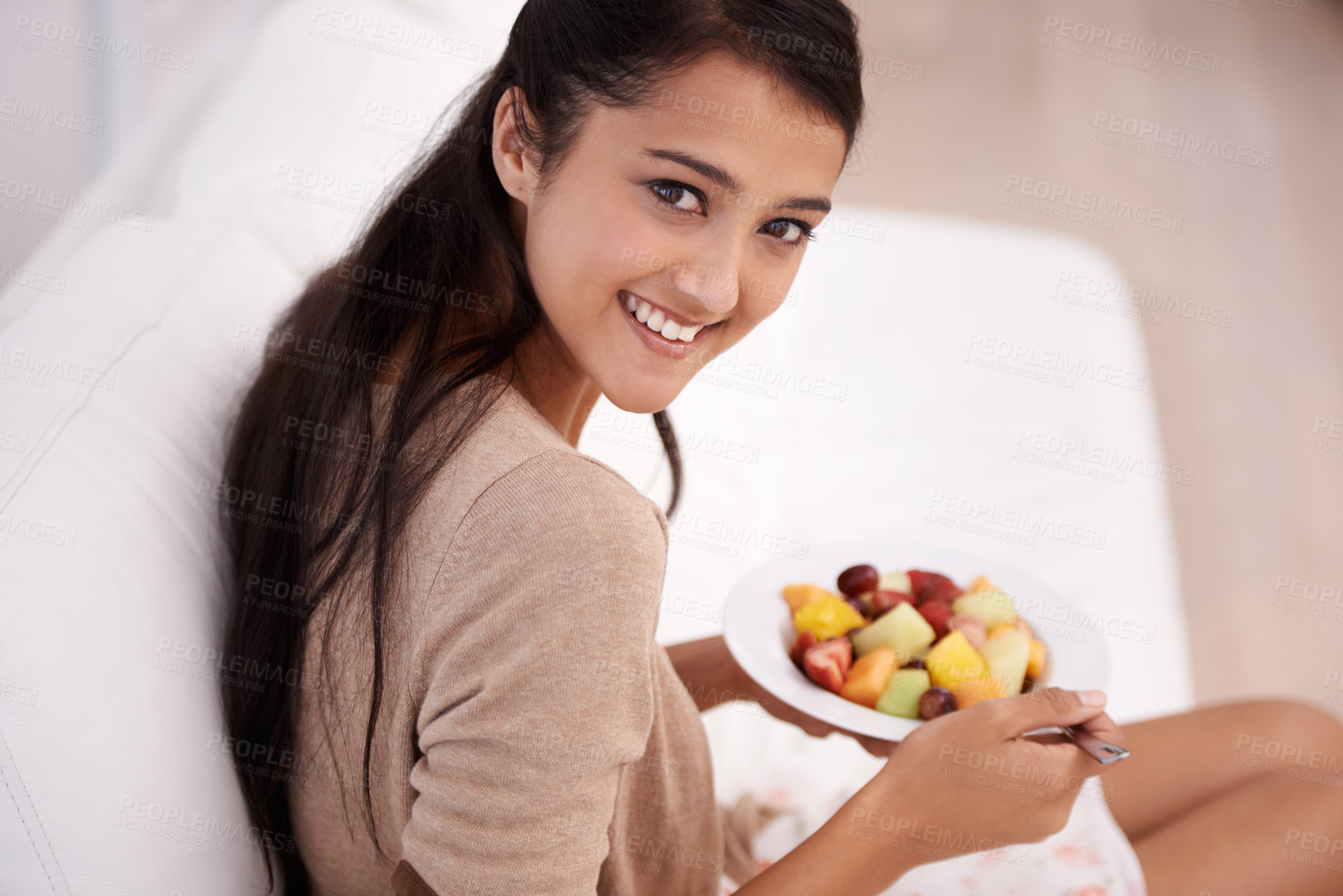 Buy stock photo Happy woman, portrait and bowl of fruit salad for diet, nutrition or healthy snack on sofa at home. Face of young female person, nutritionist or vegan smile and eating breakfast for vitamin c or meal